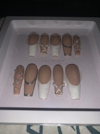 a white box containing a set of fake nails